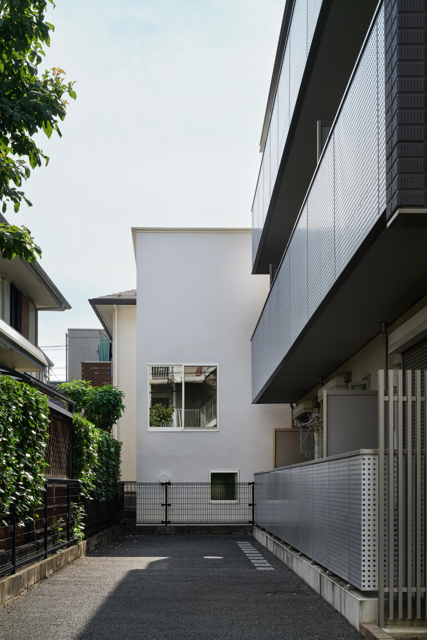 Retreat House by Arii Irie Architects — The entry sequence of Retreat House presents a compressed spatial intervention between existing brick structures.