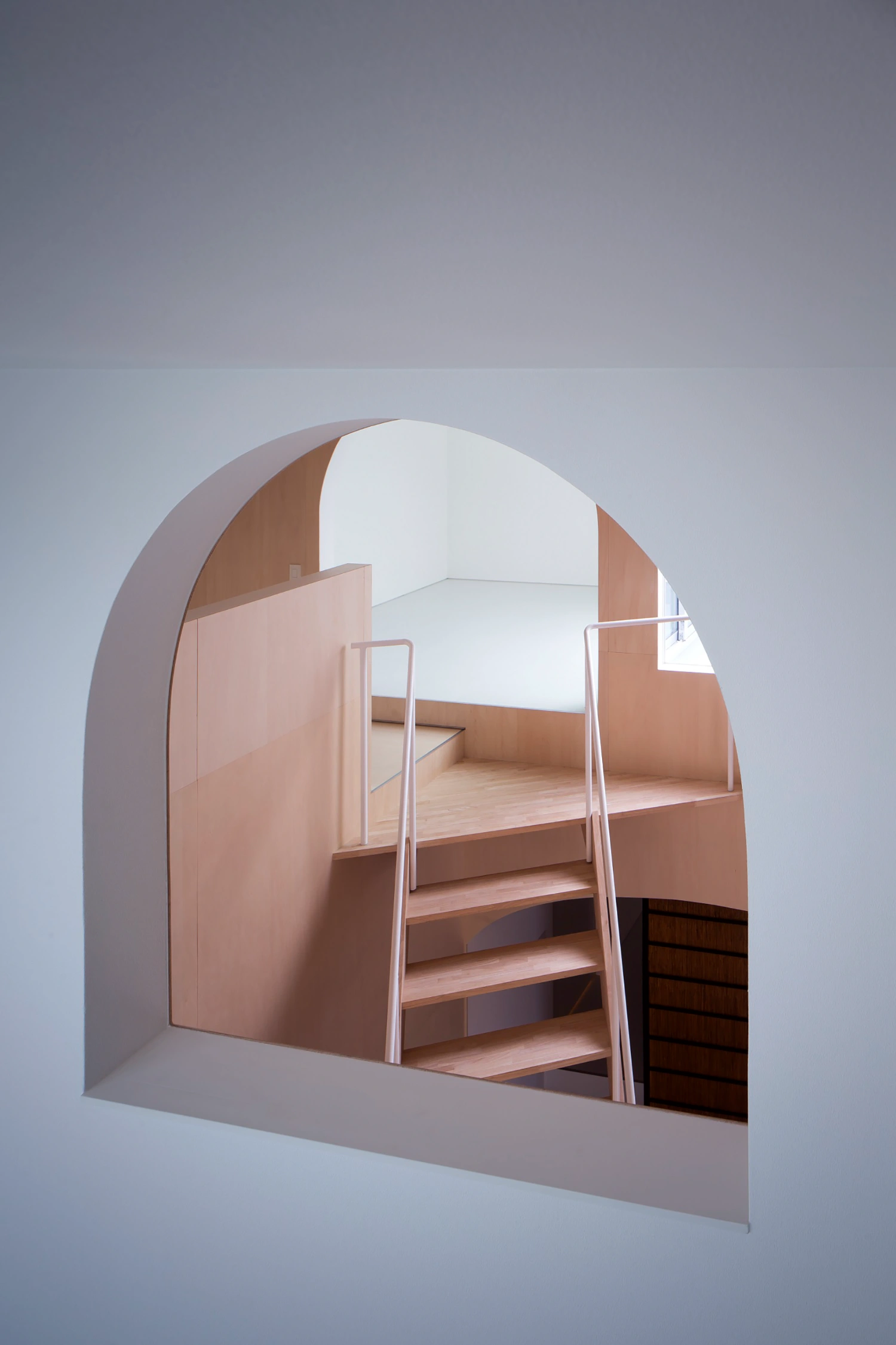 Courtyard in Kudamatsu by Container Design — A sectional view into the Courtyard passage reveals the spatial orchestration between levels.