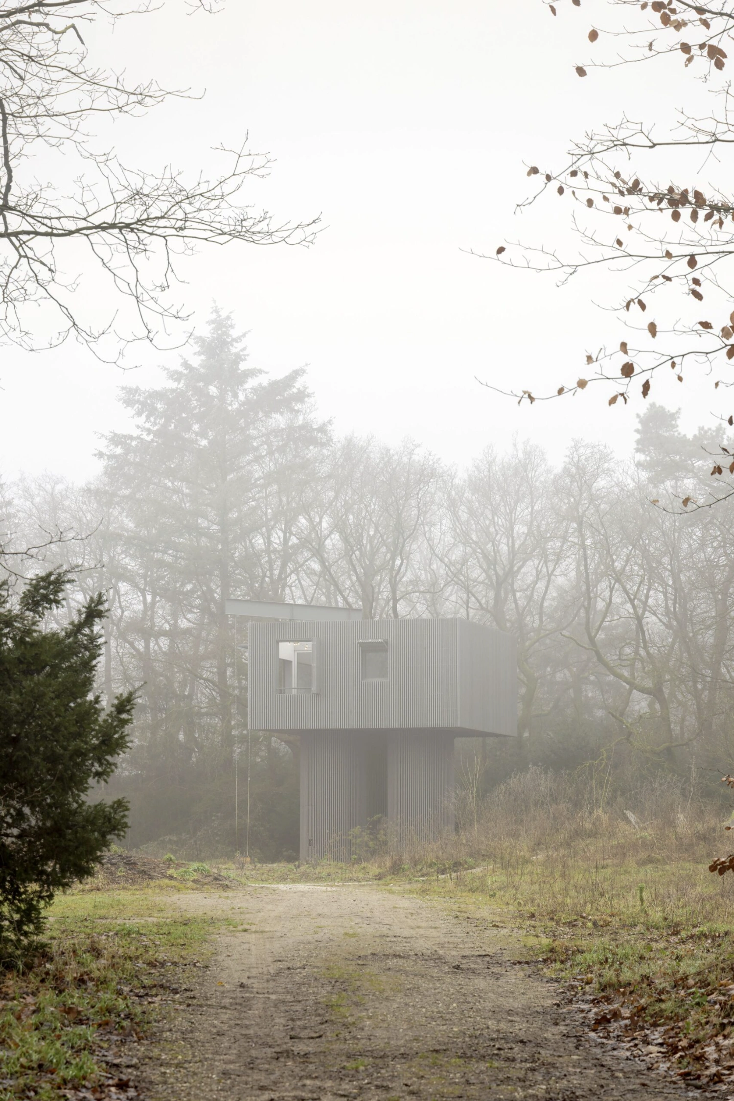 Dolmen by Space Encounters — Fog obscures the forest backdrop, rendering distant trees as grey silhouettes.