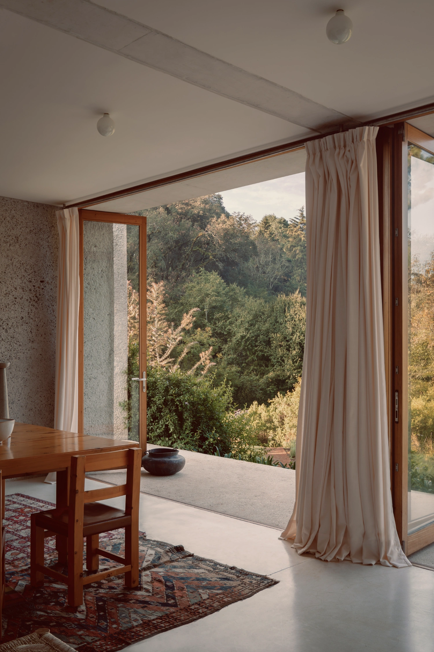 House Between Two Rivers by Taller 3000 — Interior threshold framing the landscape beyond.