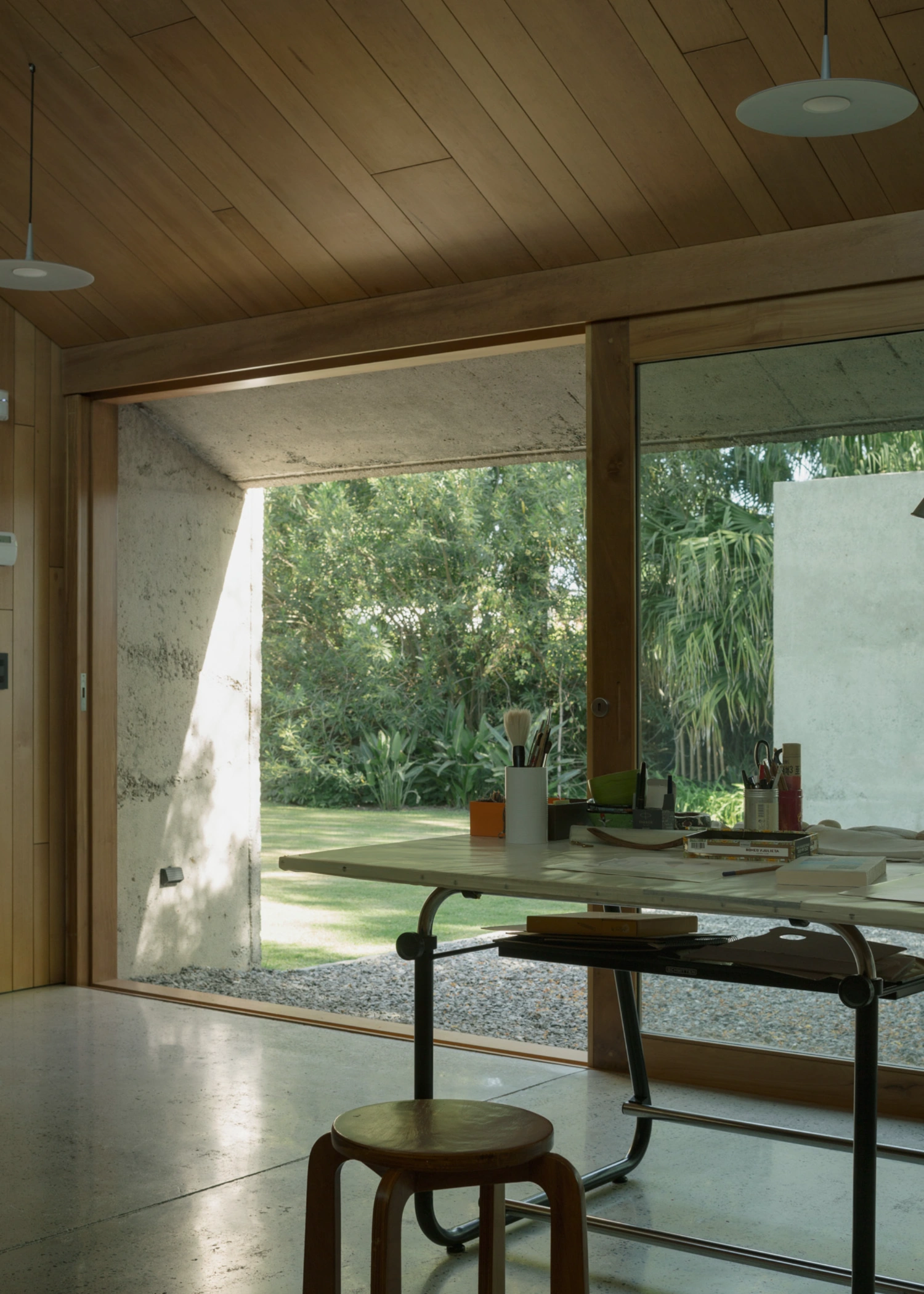 Atelier Workshop by Agustín Berzero — Interior view of the workshop capturing the threshold between controlled workspace and landscape.