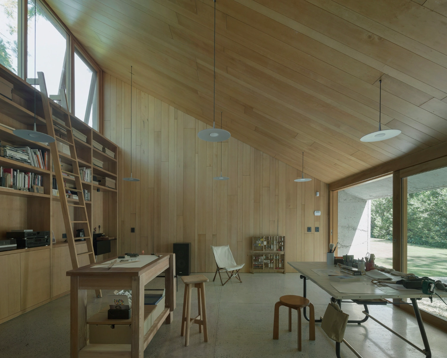 Atelier Workshop by Agustín Berzero — Interior view of the timber-lined workshop revealing the spatial organization across two volumes.