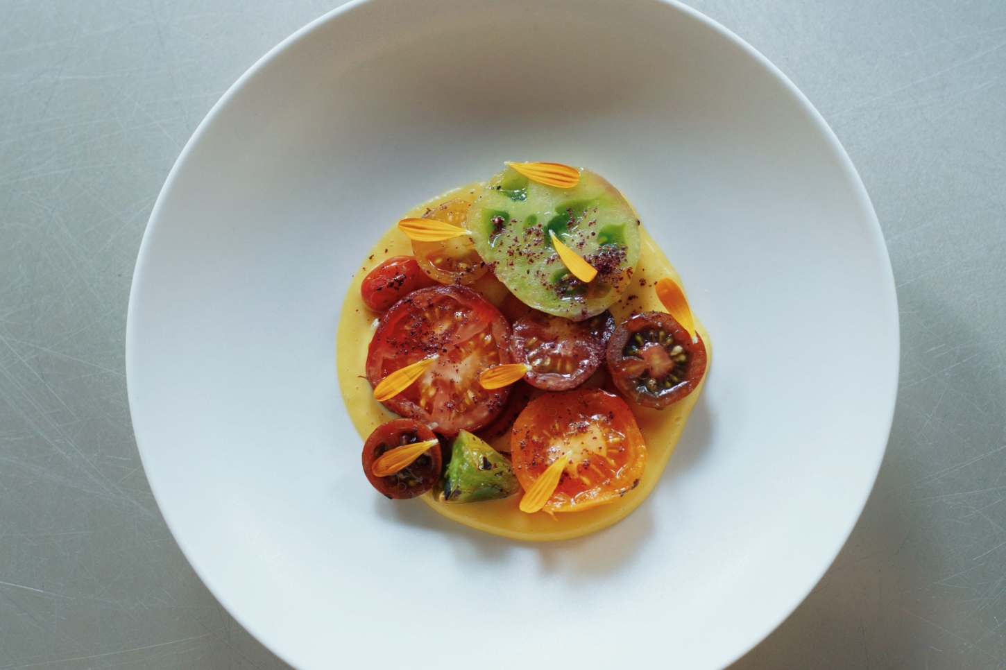 Julius in Berlin — A plated dish centered on a white ceramic plate demonstrates the kitchen's approach to refined presentation.