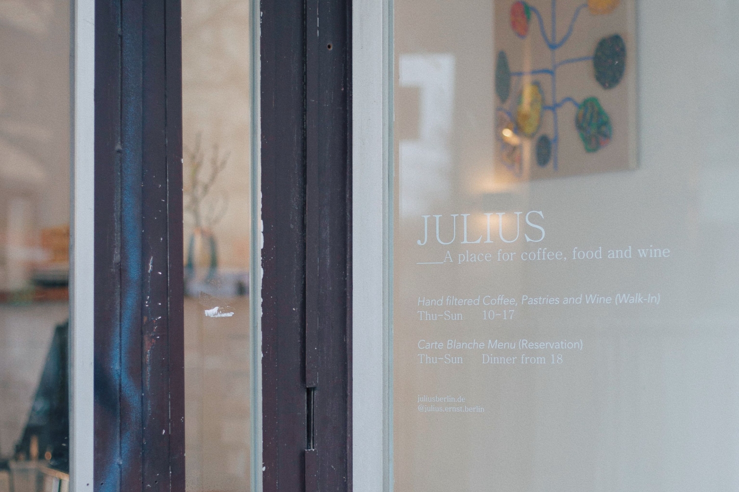 Julius in Berlin — The storefront window of Julius presents a threshold between street and interior.