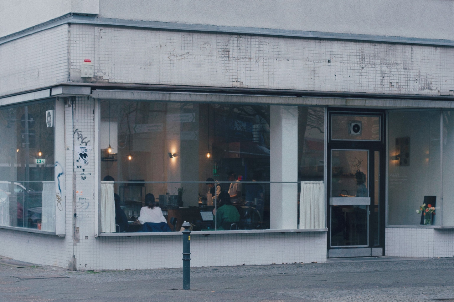 Julius in Berlin — Street-facing elevation of Julius restaurant in Wedding, Berlin, showcasing the spatial threshold between interior and urban context.