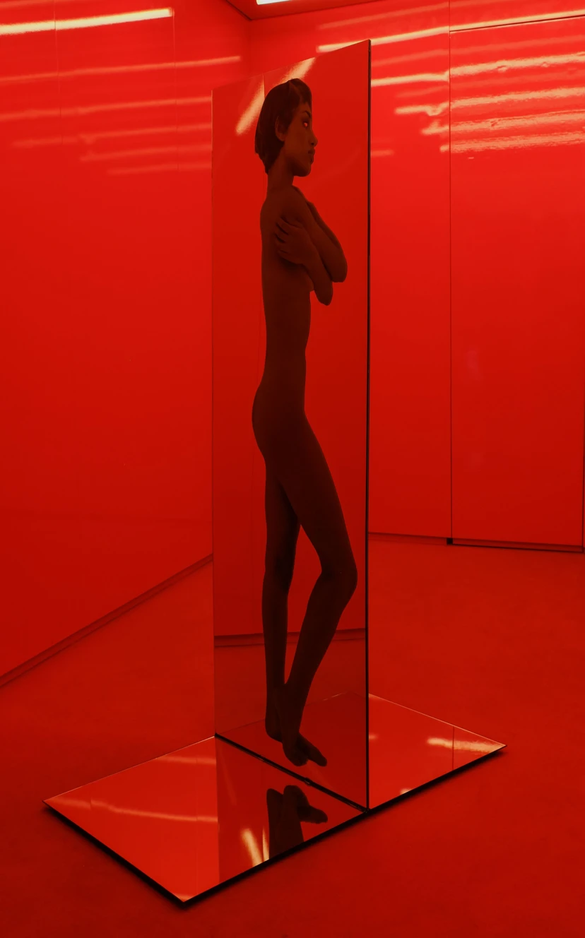 Productive Narcissism at 032c Gallery in Berlin — A figure in dark clothing stands in profile within a glass-enclosed booth, silhouetted against the saturated red interior of 032c Gallery's new Berlin space.