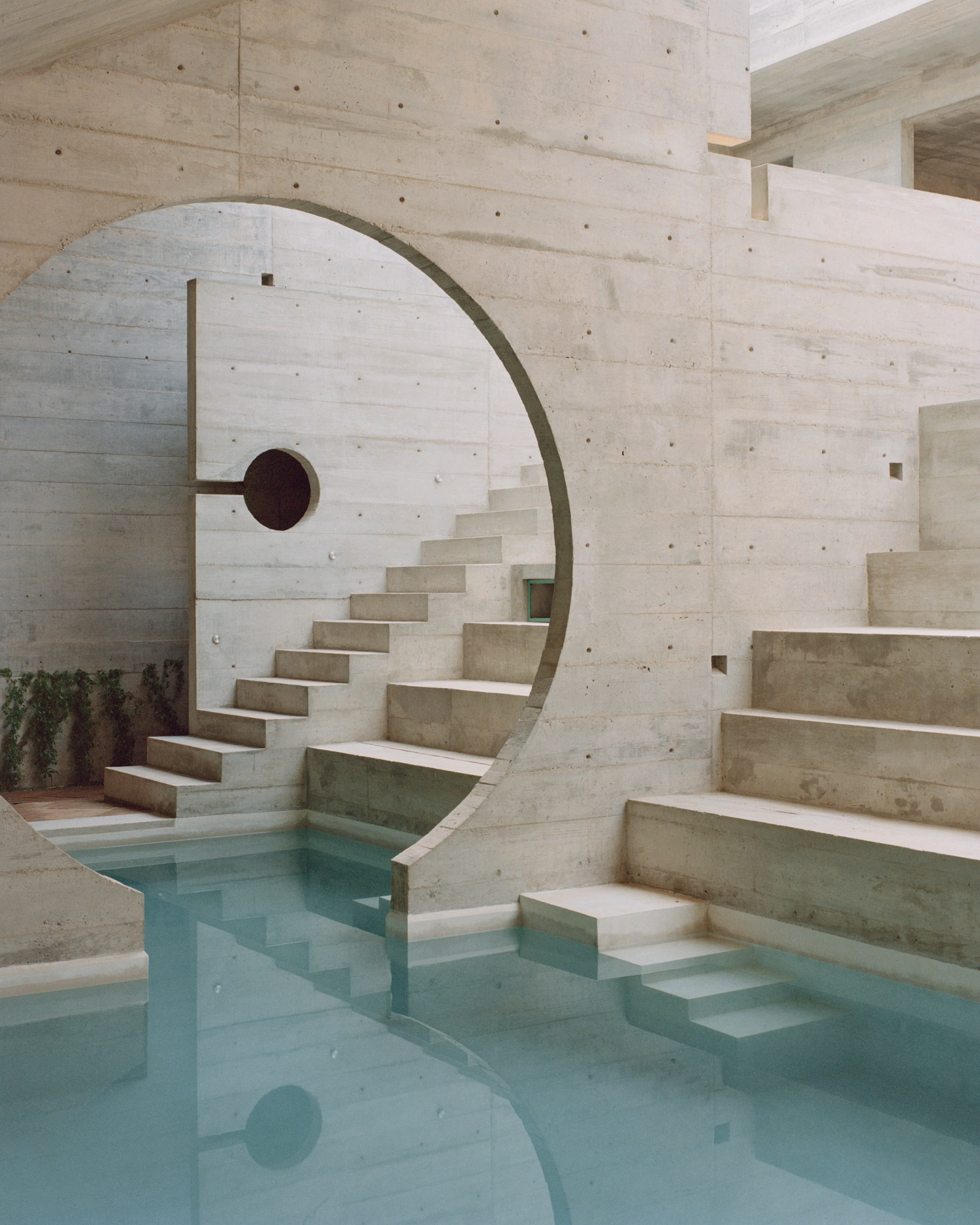 House TO by Ludwig Godefroy Architecture — A monolithic concrete interior chamber articulates space through geometric precision.