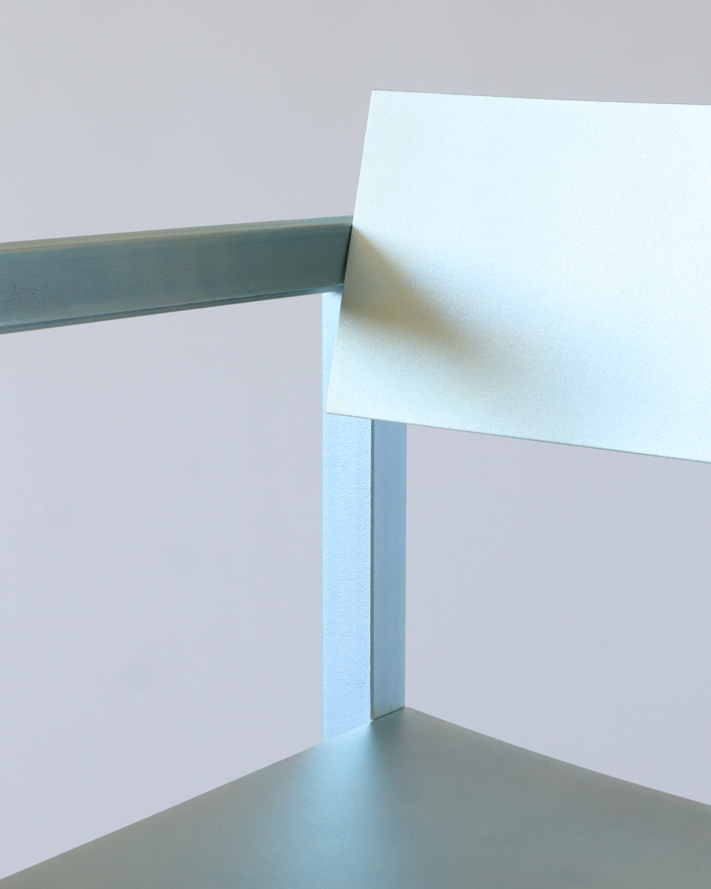 Full Metal by Matteo Bauer-Bornemann — A welded steel chair frame in powder-coated blue-grey demonstrates the project's commitment to rectilinear geometry and material honesty.