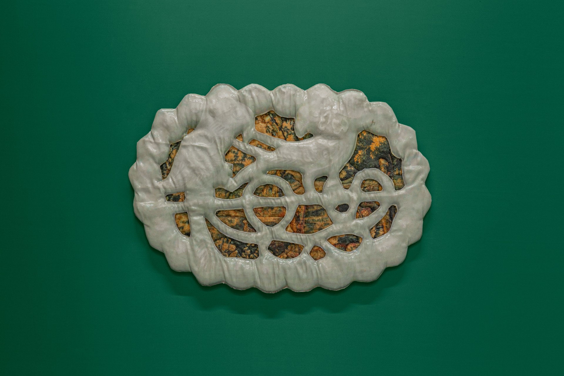 Till the cows come home at banquet — A white plaster relief panel with organic, scalloped edges dominates against the teal gallery wall.