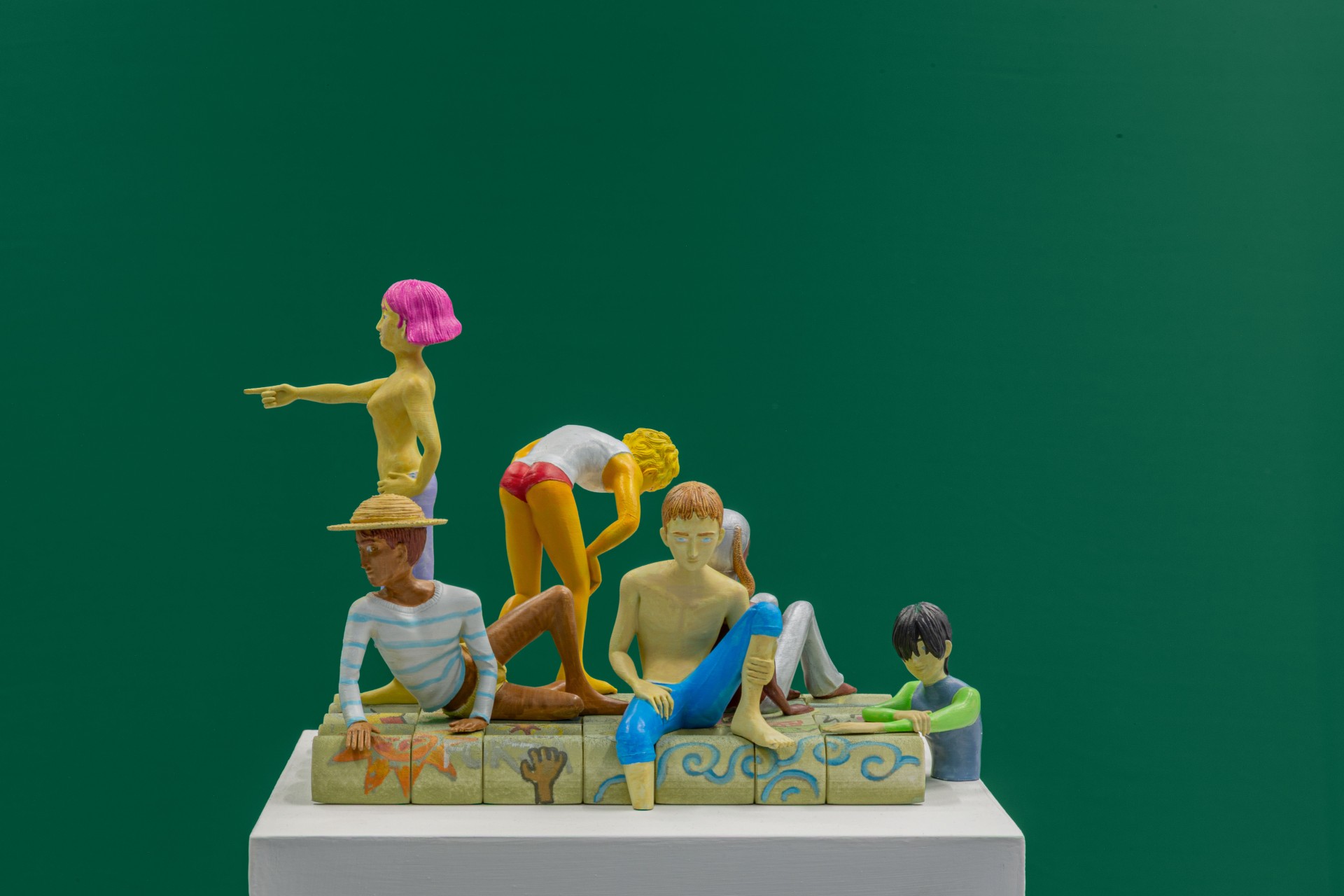 Till the cows come home at banquet — A sculptural tableau staged against a deep teal wall features five figurative forms in varying scales arranged on a cream-colored plinth.