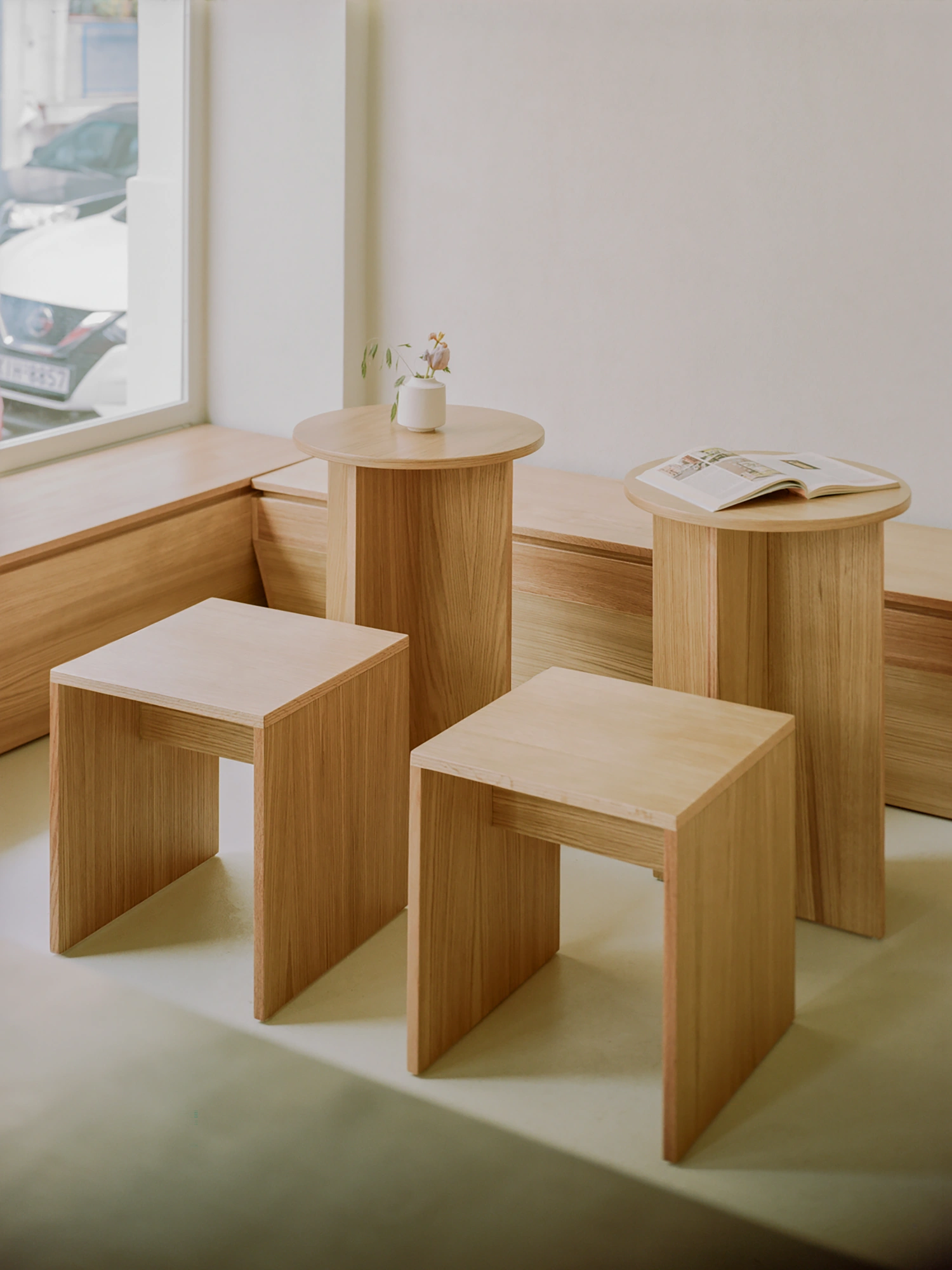 Moden Café by Georgios Apostolopoulos — A window-side seating arrangement in Moden Café showcases bespoke oak furniture with minimal detailing.