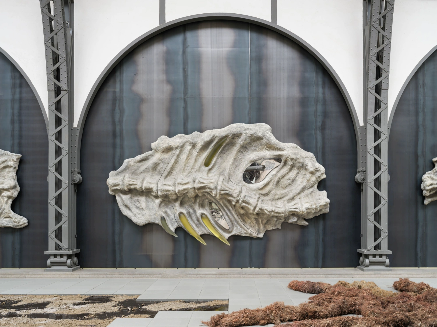 'embrace' by Klára Hosnedlová at Hamburger Bahnhof — Within the cavernous 2,500-square-meter industrial hall, a monumental white plaster sculptural head emerges from the central woven flax column, its profile...