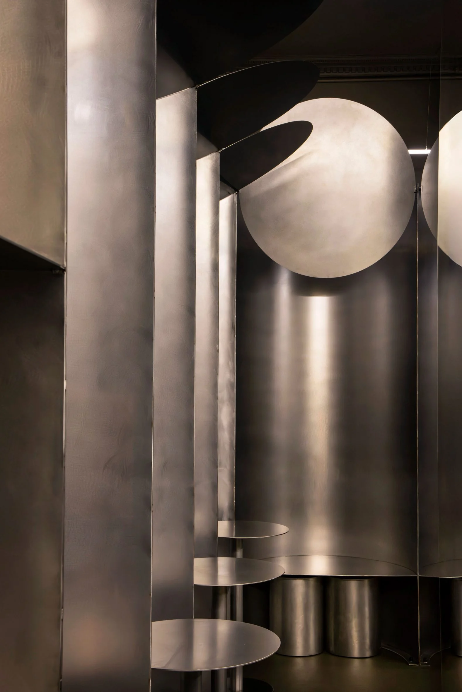 Simple Coffee by Mur Mur Architects — A sectional view into Simple Coffee reveals the spatial logic of Mur Mur Architects' metallic intervention.