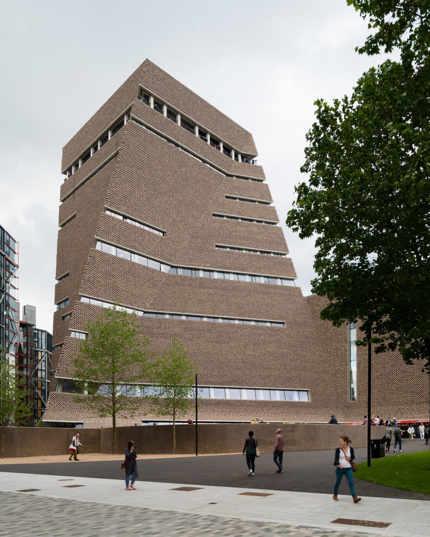 The Tate Modern by Herzog & de Meuron — Herzog & de Meuron's conversion of Bankside Power Station preserves Giles Gilbert Scott's brick tower as a monolithic vertical form.