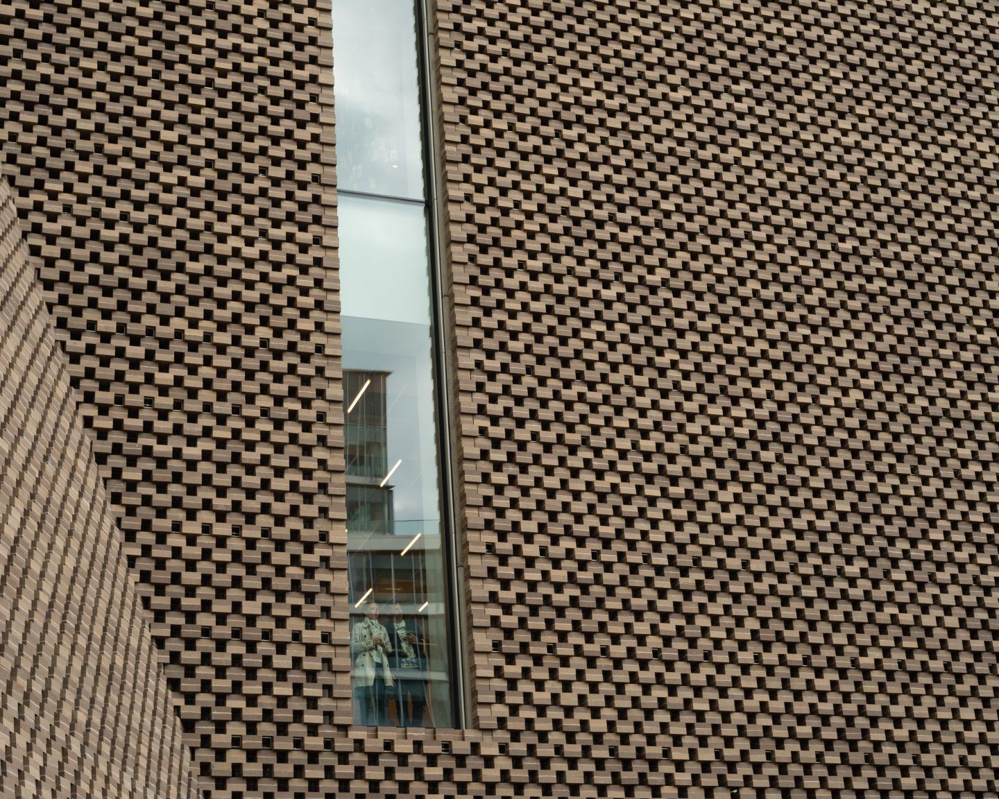 The Tate Modern by Herzog & de Meuron — A narrow passage between two brick facades reveals the architectural intervention at the heart of Herzog & de Meuron's Tate Modern conversion.