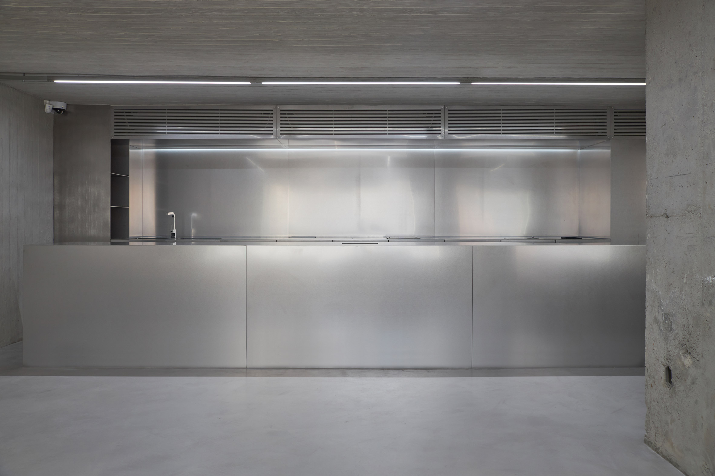 HAHOUSE Cafe by Niceworkshop — The cafe counter presents a studied composition of material juxtaposition.