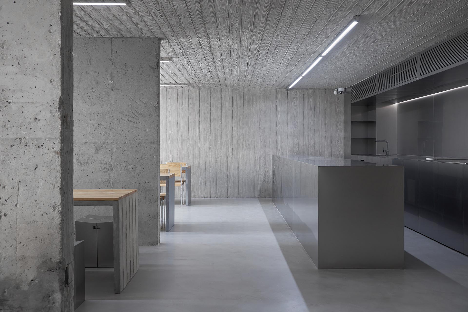 HAHOUSE Cafe by Niceworkshop — The cafe interior reveals a material hierarchy through spatial progression.