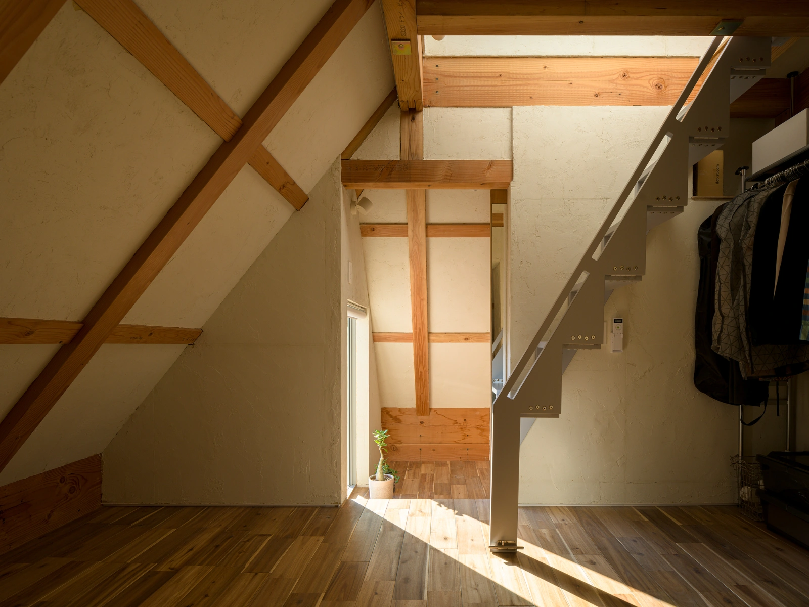 Small House on a Corner Lot by KOMINORU Design — A timber-framed attic interior reveals the structural logic governing this constrained Tokyo dwelling.