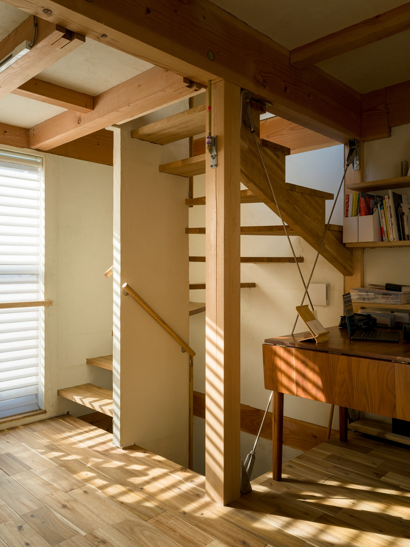 Small House on a Corner Lot by KOMINORU Design — Interior stairwell demonstrating vertical spatial economy within the 30-square-meter constraint.