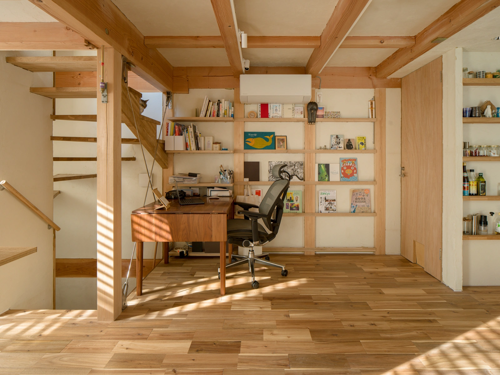 Small House on a Corner Lot by KOMINORU Design — A three-story wooden interior office demonstrates spatial efficiency within tight urban constraints.