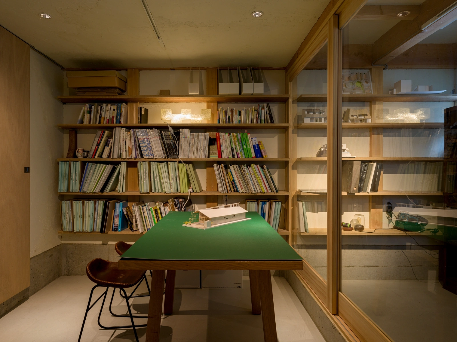 Small House on a Corner Lot by KOMINORU Design — A wood-lined study nook demonstrates vertical spatial organization within the constrained footprint.