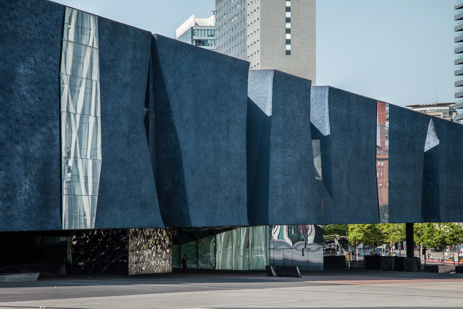 Museu Blau by Herzog & de Meuron — Denis Esakov's photograph captures the Museu Blau's monolithic concrete facade from ground level, emphasizing its massive triangular geometry.