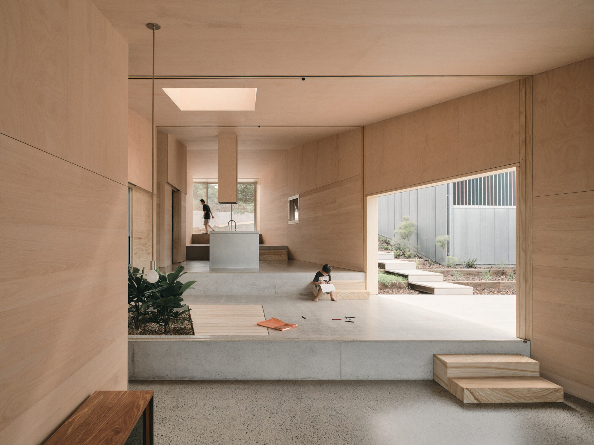 Mapleton House by Atelier Chen Hung — The open-plan interior is experienced from a lowered threshold, framing the space as a unified volumetric sequence.
