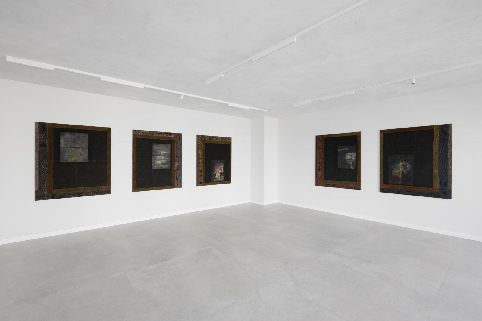 What You See is Not Here Tomorrow by Radek Brousil at Krupa Gallery — Five framed artworks with patinated wooden borders and dark matting are installed across two walls of a white-painted gallery space.