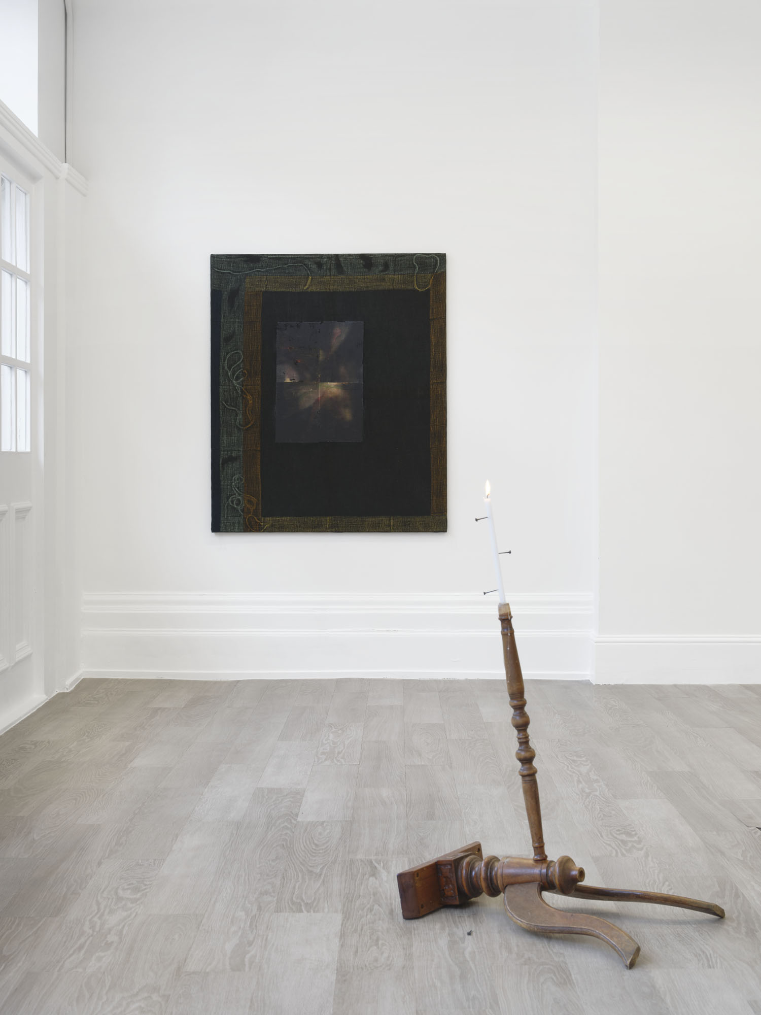 What You See is Not Here Tomorrow by Radek Brousil at Krupa Gallery — A wooden tripod floor lamp with turned spindle support and angled leg occupies the gallery floor, its dark patinated wood surface contrasting against...