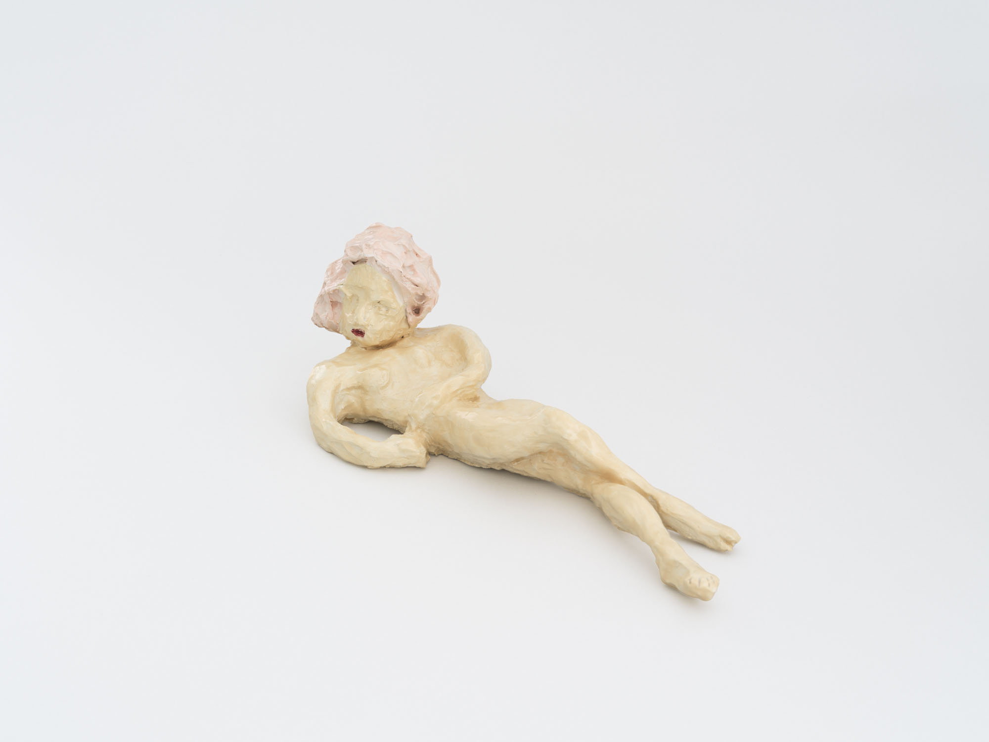 Four Minutes After Sunset by Rudy Cremonini at Capsule Shanghai — A pale limestone or alabaster sculpture depicts a reclining figure in repose, head tilted back and body stretched horizontally across the gallery floor.