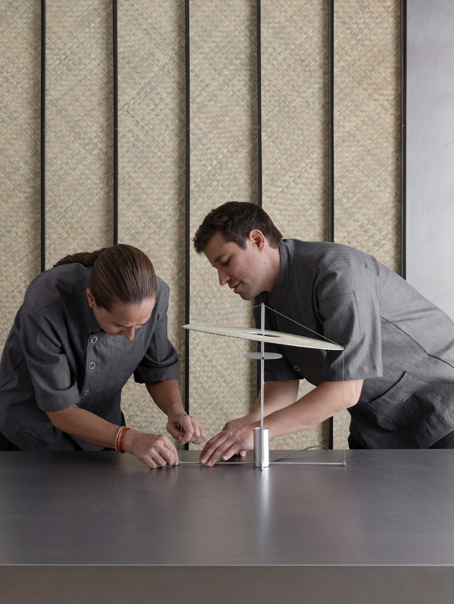 Cilia by Studio Davidpompa — Two designers examine a prototype of the Cilia lamp during its development phase.