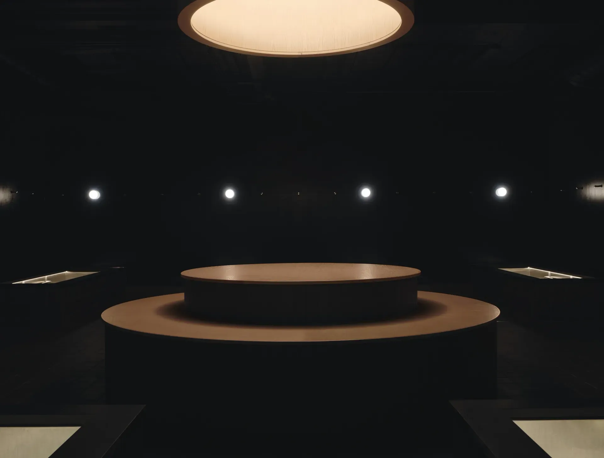 Arc Canary Wharf by Cake Architecture — The amphitheatre-style lounge features concentric curved bench tiers descending toward a central void, rendered in terracotta and warm golden tones.