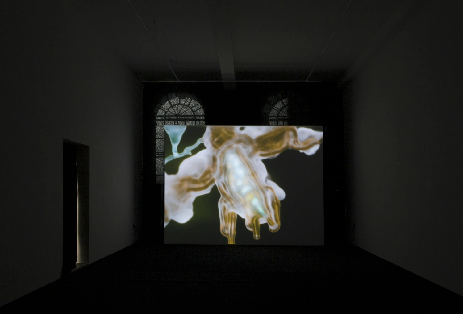 The Book of Flowers by Agnieszka Polska at Union Pacific — A projected video artwork dominates the gallery wall, displaying a digitally rendered flower with pale white petals and golden-yellow stamens against a soft...