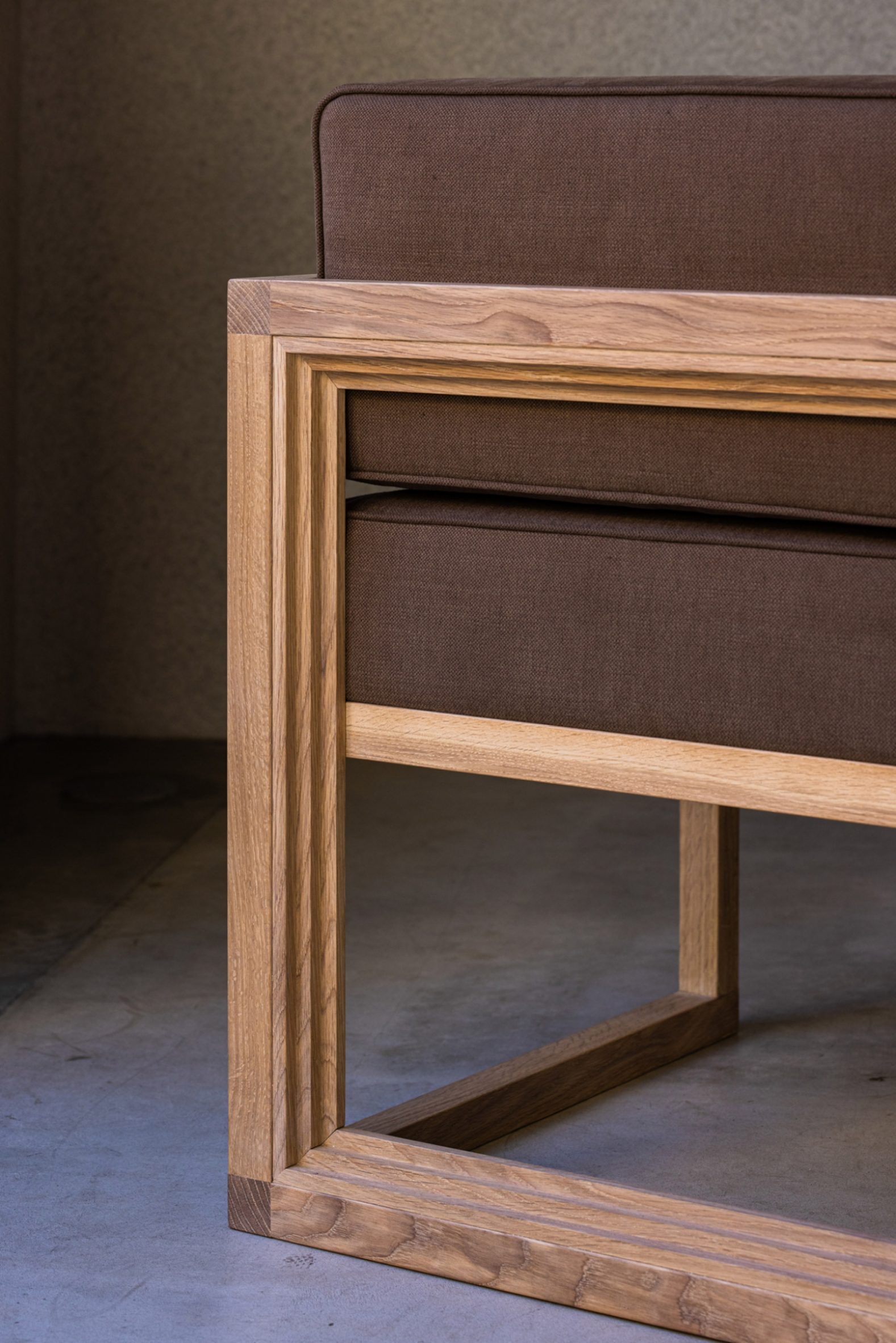 Koffee Mameya Kakeru by Fourteen Stones Design — Detail view of a wooden bed frame with integrated upholstered headboard.