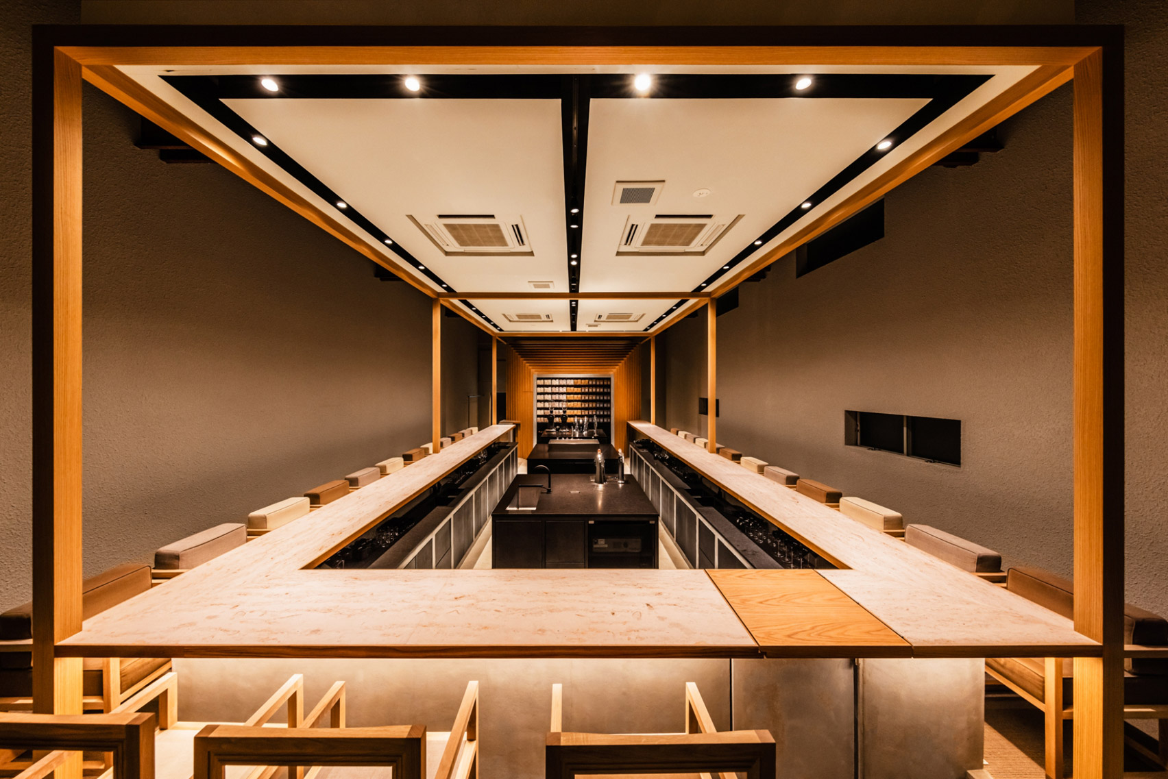 Koffee Mameya Kakeru by Fourteen Stones Design — Interior view of the elevated counter platform, framed by the full-height glass storefront.