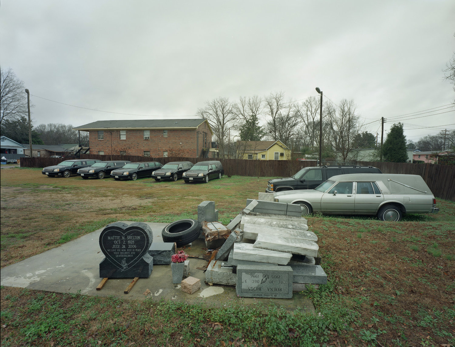 Funeral Homes of the American South by Timothy Hursley — A graveside arrangement in a rural Southern yard documents the material traces of funeral preparation.