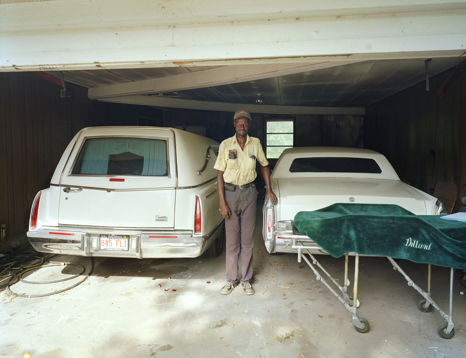 Funeral Homes of the American South by Timothy Hursley — Unlike the project's typical vacant interiors, this image presents a rare human presence within a funeral home garage.