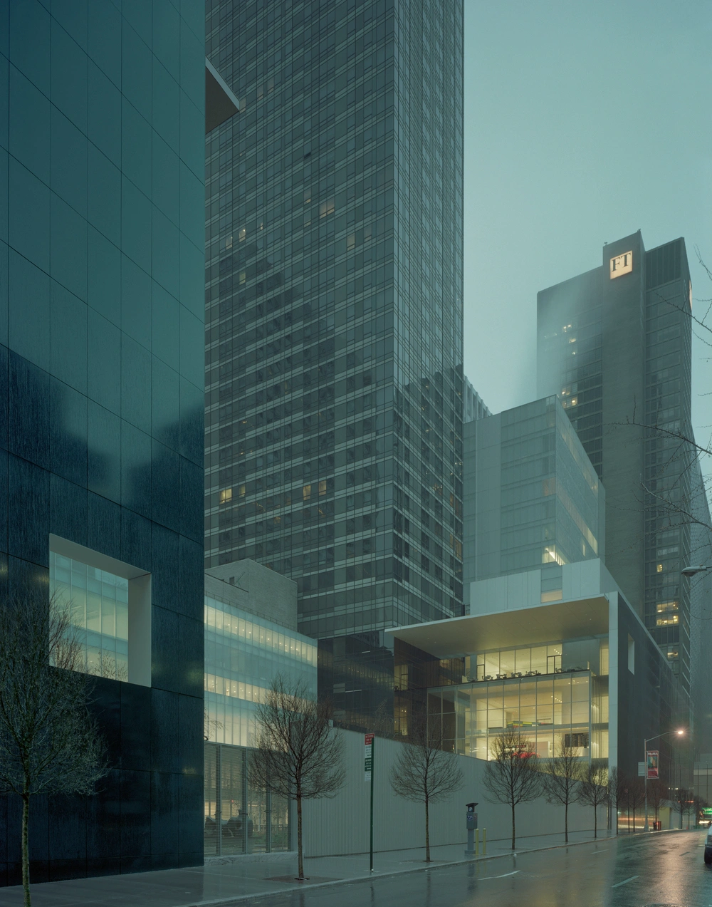 Museum of Modern Art in New York by Yoshio Taniguchi — Evening photograph of MoMA's street-level facade, where Taniguchi's 2004 expansion meets the urban streetscape.