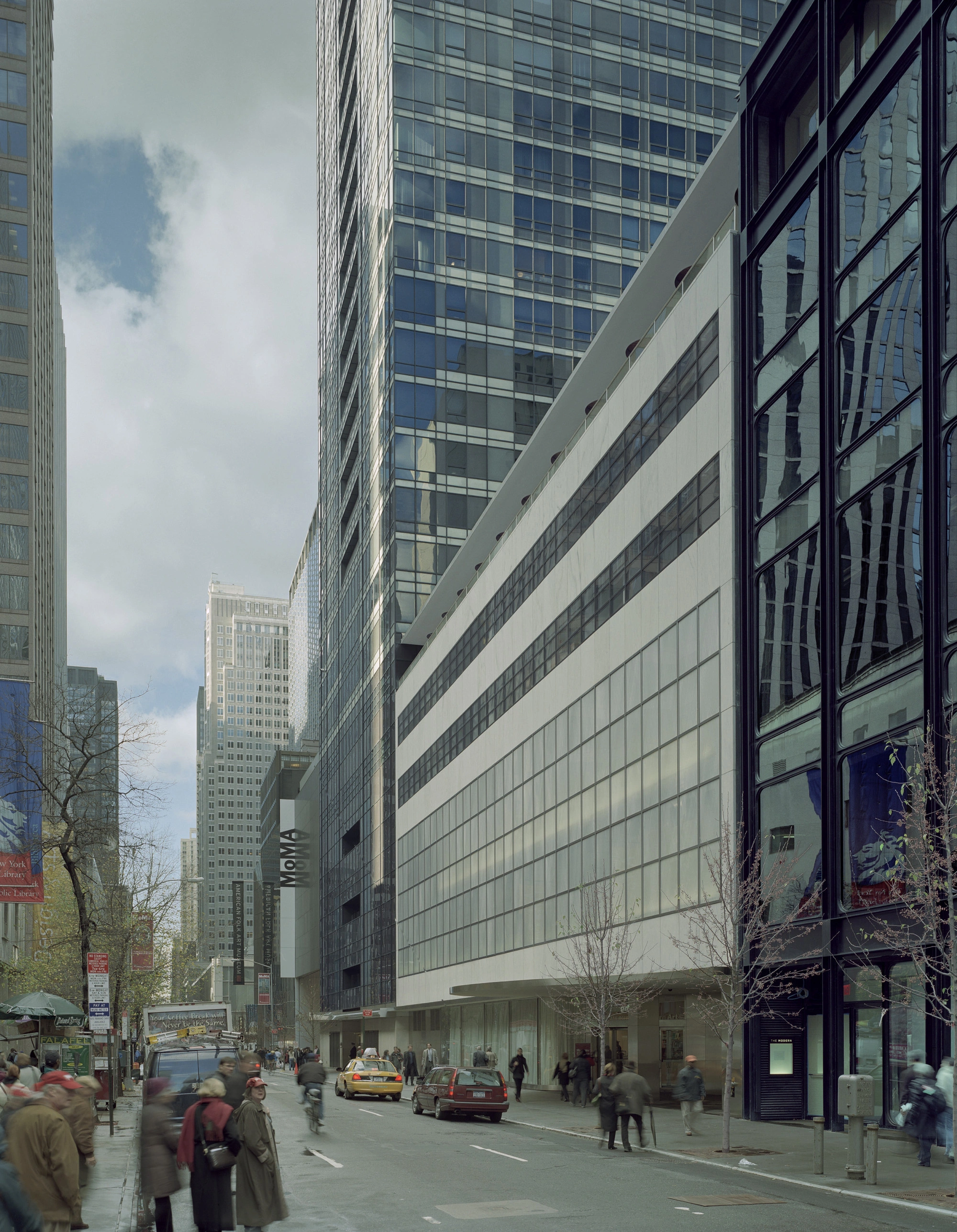 Museum of Modern Art in New York by Yoshio Taniguchi — Street-level perspective of MoMA's 2004 expansion reveals the design's commitment to transparency and visual continuity.