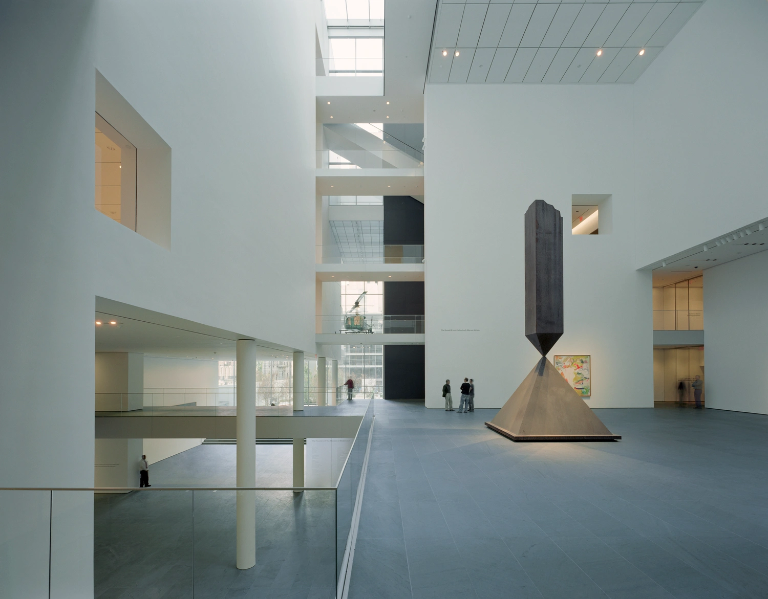 Museum of Modern Art in New York by Yoshio Taniguchi — A multi-story atrium showcases Taniguchi's spatial stratification through stacked horizontal planes connected by thin cylindrical columns.