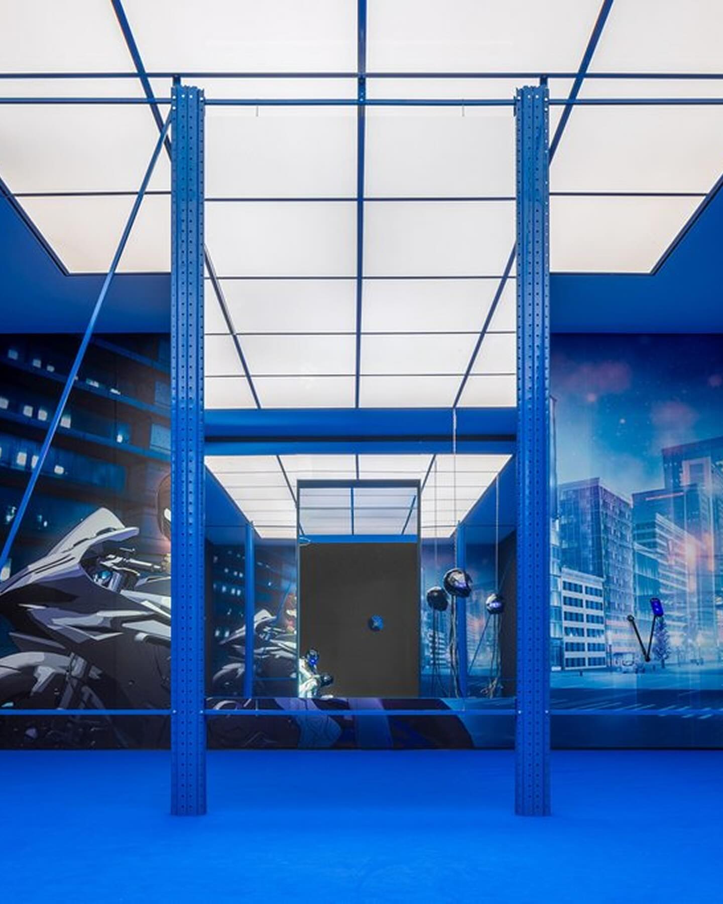 Many Worlds Over by Ayoung Kim at Hamburger Bahnhof — A monolithic steel pavilion occupies the gallery floor, its bright cobalt-blue painted columns and diagonal bracing establishing a geometric cage.