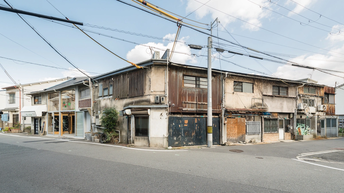 Chidori-Bunka by Dot Architects — A street-corner view of the renovated Chidori-Bunka structure reveals the project's material layering and preservation strategy.