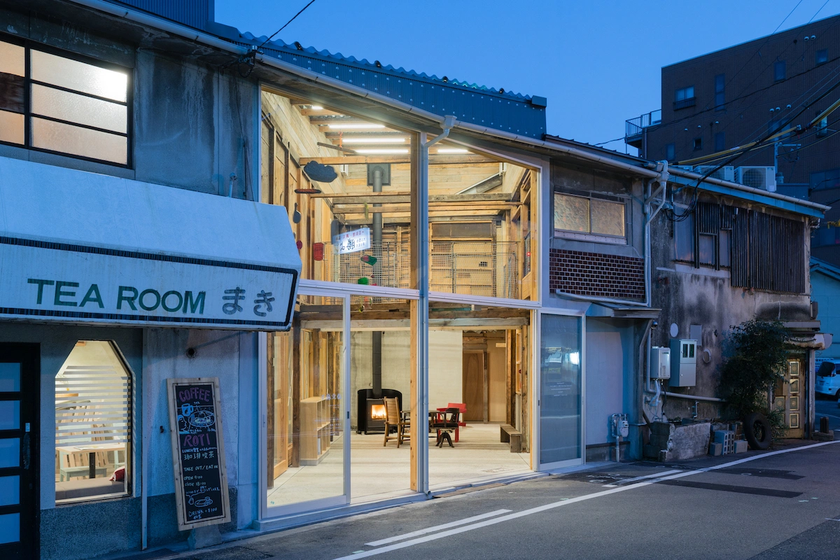 Chidori-Bunka by Dot Architects — A tea room occupies a renovated corner storefront in Osaka, its transparent frameless glass facade revealing interior activity at dusk.
