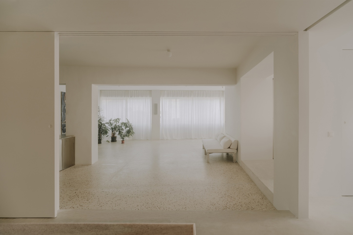 'Astral Weeks' by Oblique — A perspectival view through open sliding panel doors reveals the spatial strategy of 'Astral Weeks': a continuous terrazzo aggregate floor unifies the depth...