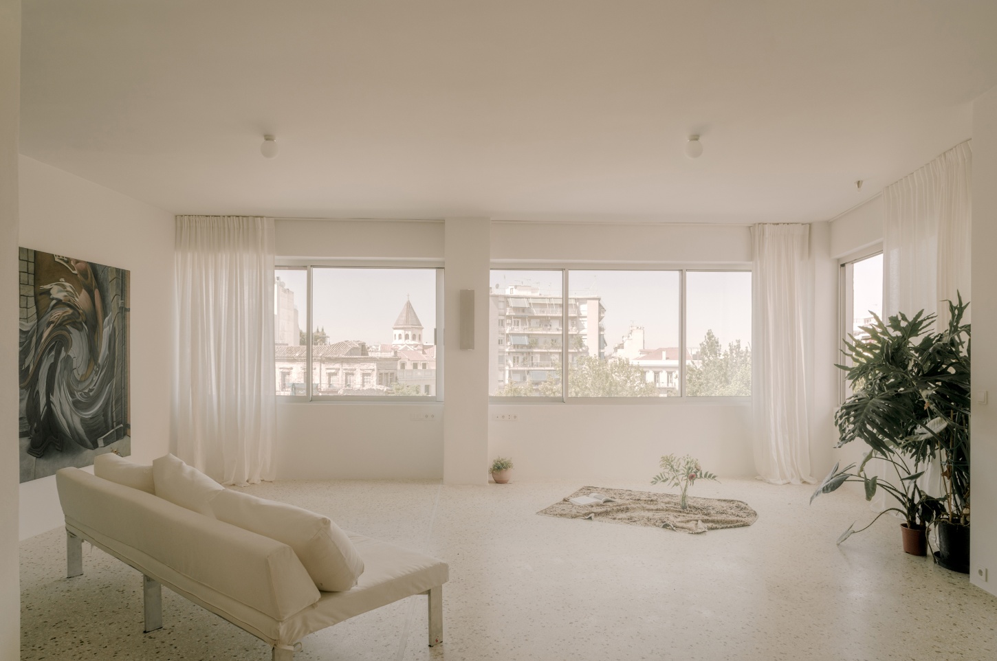 'Astral Weeks' by Oblique — A high-ceilinged residential interior within a converted 1970s office building presents a deliberately sparse arrangement.