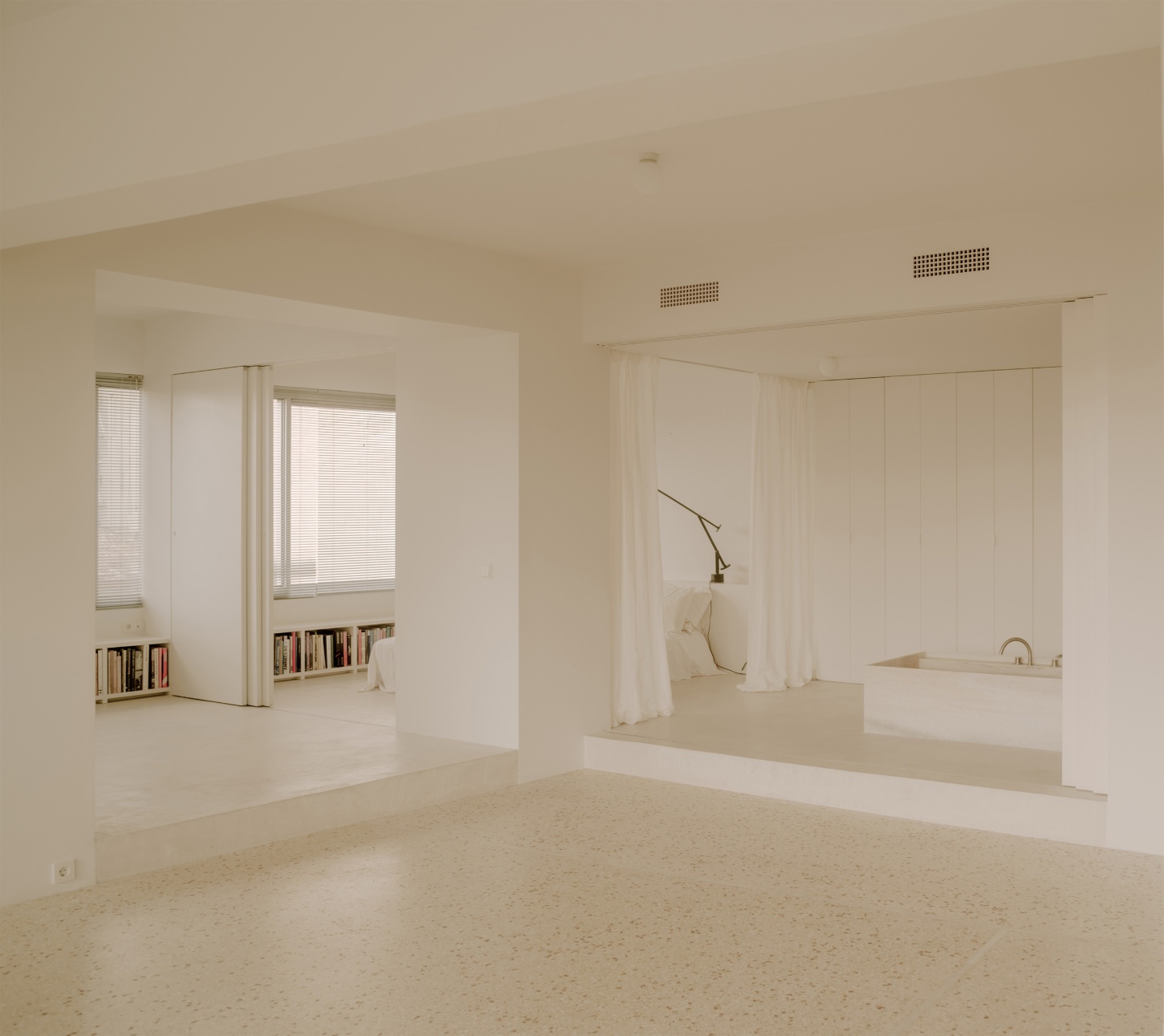'Astral Weeks' by Oblique — A minimalist residential interior navigates the structural constraints of its 1970s postwar office building typology.