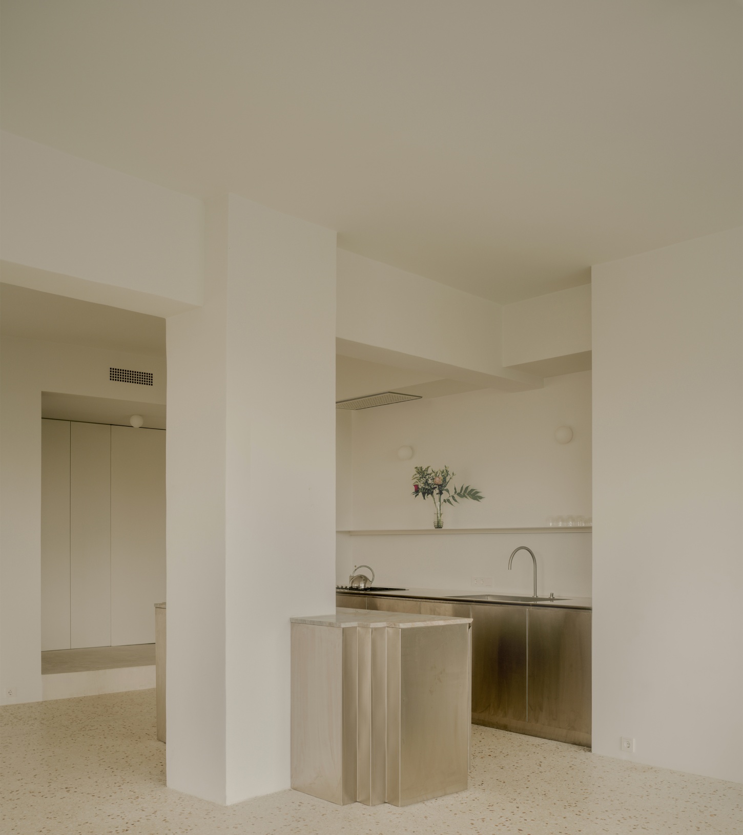 'Astral Weeks' by Oblique — A kitchen alcove carved into the postwar office building's structural grid, defined by load-bearing columns that fragment the open-plan layout.