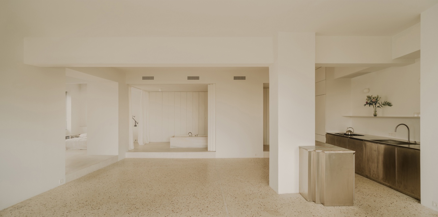'Astral Weeks' by Oblique — The open-plan interior reveals a load-bearing column structure dividing the 1970s office conversion into zones: a central terrazzo aggregate floor anchors...