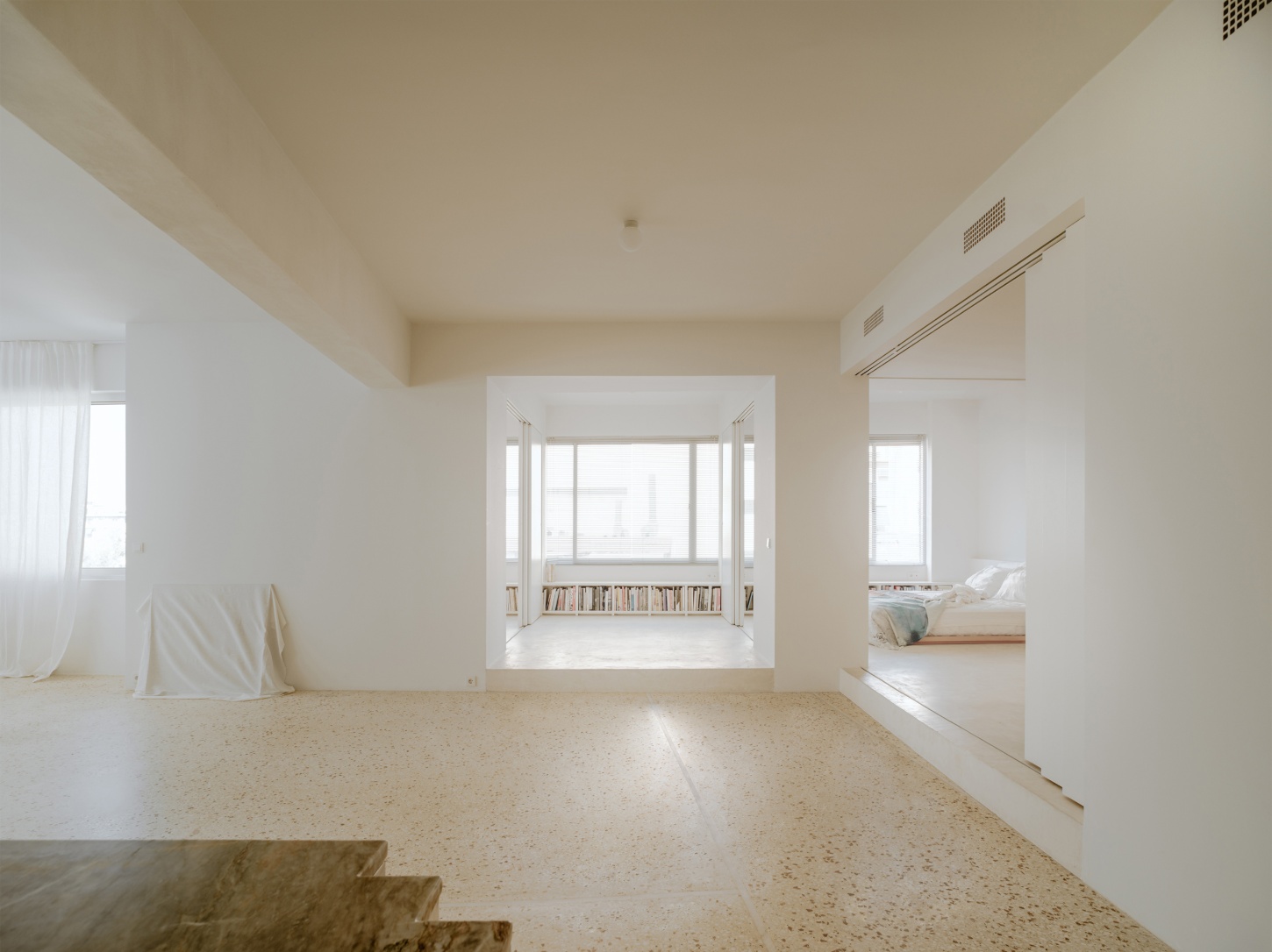 'Astral Weeks' by Oblique — A multi-chambered living space negotiates the structural constraints of its 1970s office building host through spatial subdivision and material continuity.