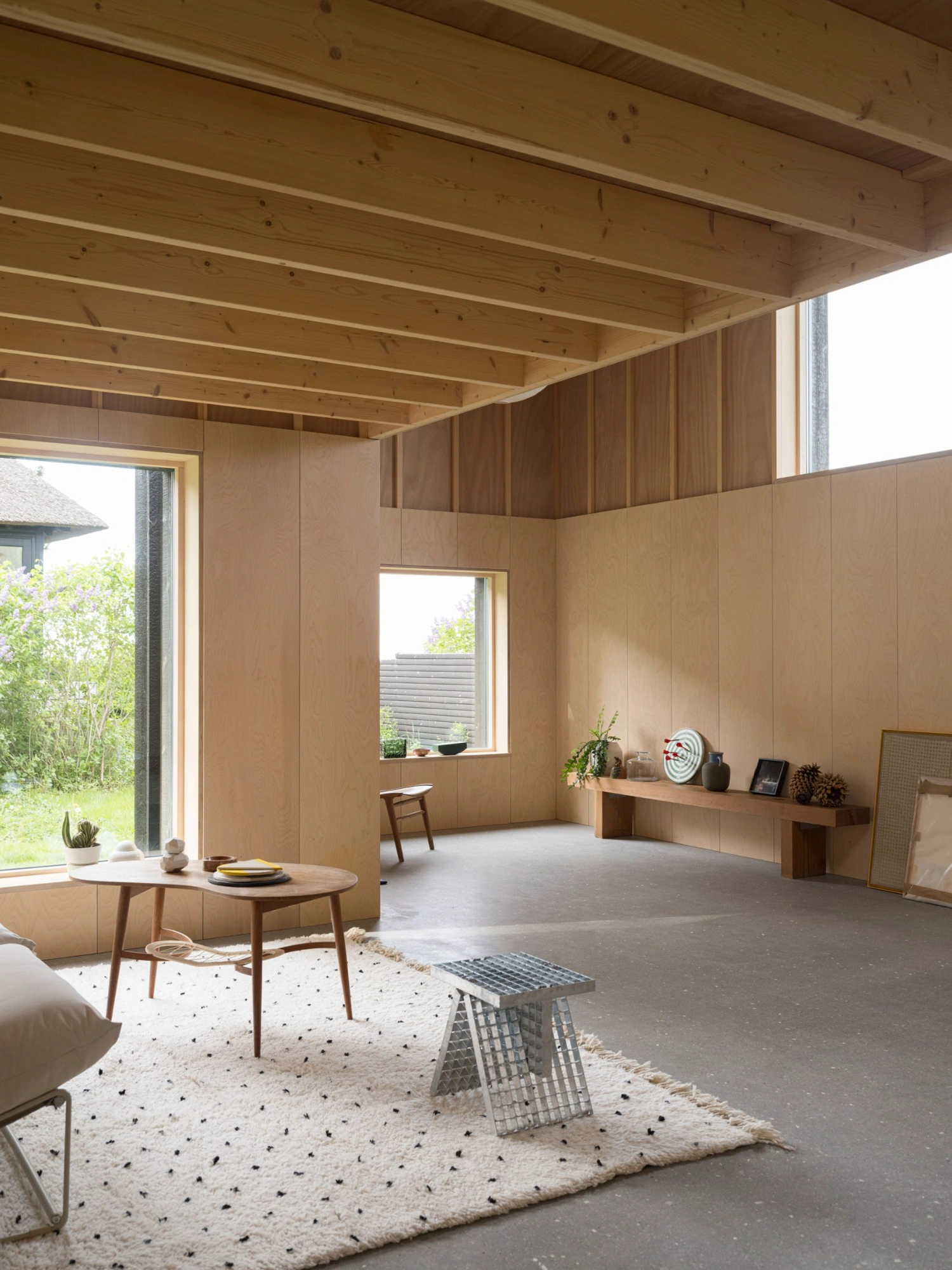 House with a Hidden Atrium by Förstberg Ling — Interior view of the extended cabin's central atrium space, defined by verticality and material contrast.